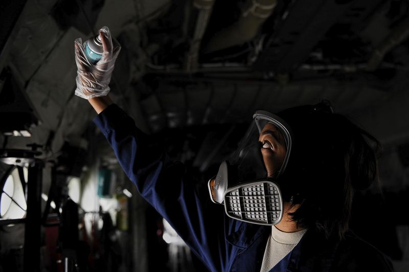 Airman 1st Class Arielle Howze, 786th Civil Engineer Squadron pest management journeyman, sprays aircraft insecticide in