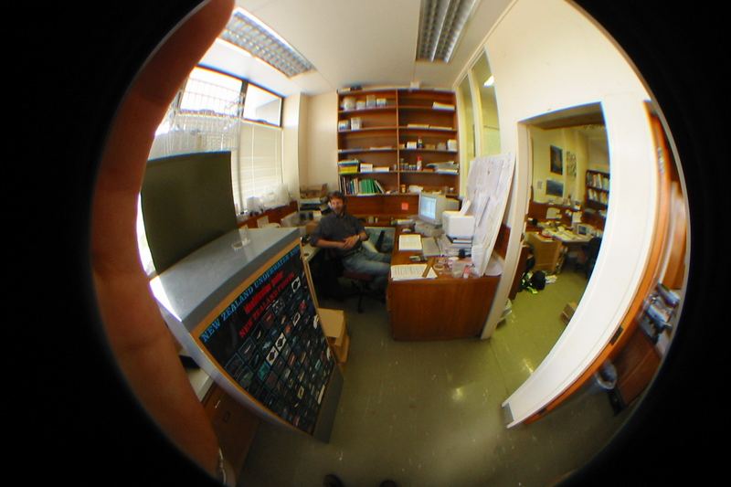 Chris Winks in his Landcare Research office, Mt. Albert, Auckland, New Zealand, seen through fish-eye lens.